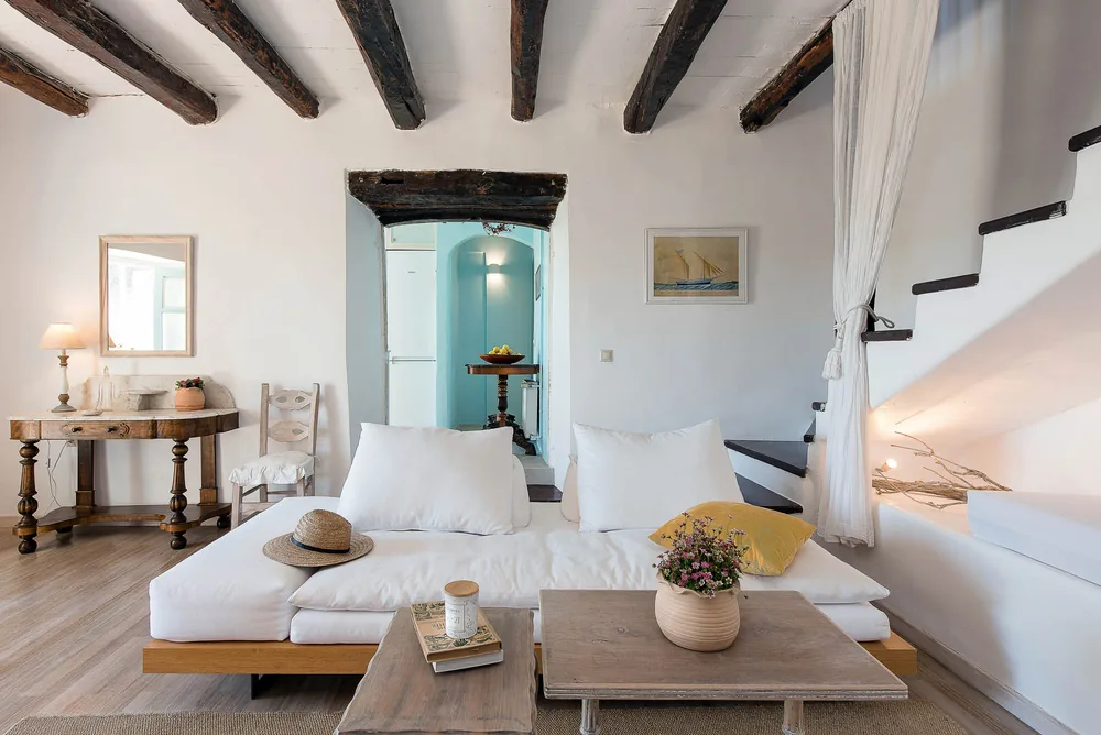 Bright living room in one of our Corfu cottages, with white walls and wooden beams